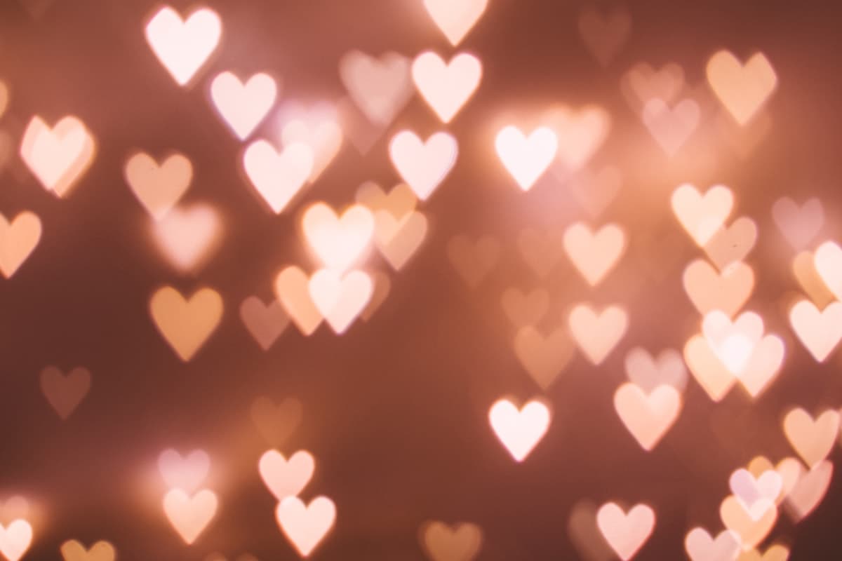 Broken heart paper on pink background representing Valentine's Day heartbreak